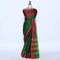 A green cotton saree with a rich magenta and gold border