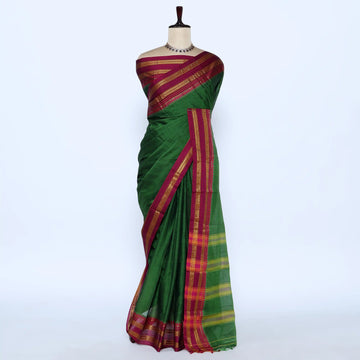 A green cotton saree with a rich magenta and gold border