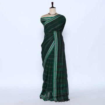 A dark green saree with a subtle plaid pattern and a contrasting border of white and light green stripes