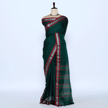 A dark green saree with red and silver patterned borders