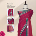 A magenta pink saree with green and white borders with head, blouse, and pallu. 