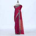 A magenta pink cotton saree with green and gold stripes