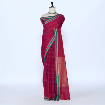 A magenta pink cotton saree with green and gold stripes