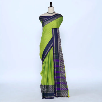 A green and navy blue saree with purple and gold patterned borders