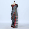 A gray cotton saree with red and gold borders best for daily wear