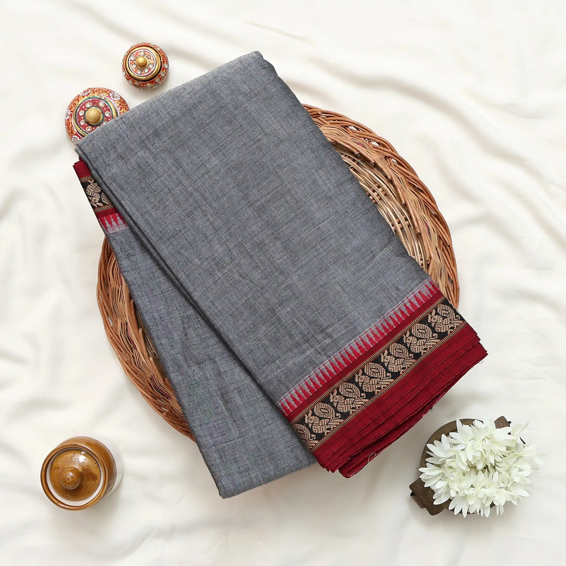 A gray cotton saree with red and gold borders best for daily wear