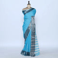 A light blue cotton saree with a metallic silver border and striped pallu