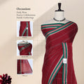 A deep red saree with green and white border patterns  along head , blouse, and pallu. 