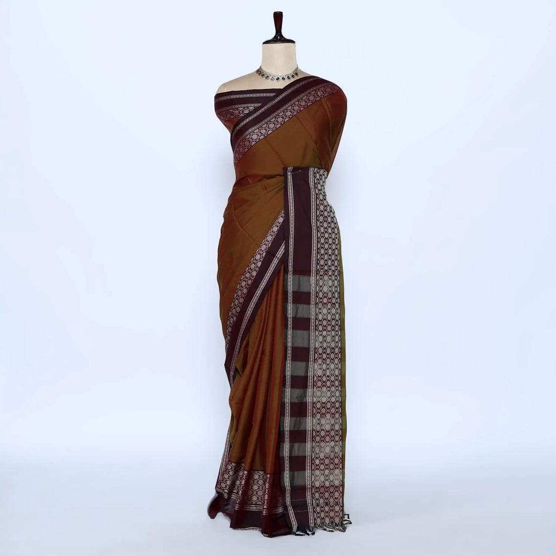 A brown cotton saree with a patterned border