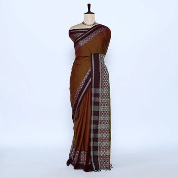 A brown cotton saree with a patterned border
