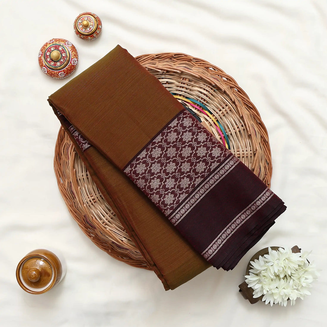 A brown cotton saree with a patterned border