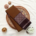 A folded brown and deep maroon patterned fabric