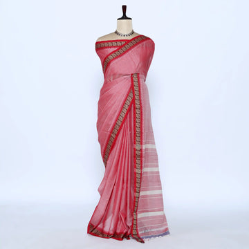 A pink cotton saree with a striped pallu and a gold patterned border