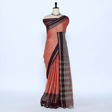 A peach-colored saree with dark brown borders and a patterned pallu
