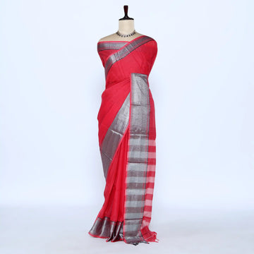 A red cotton saree with a silver metallic zari border and pallu