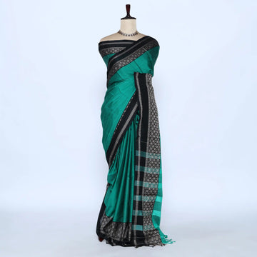 A green and black saree features a solid green body with black borders and a patterned pallu.