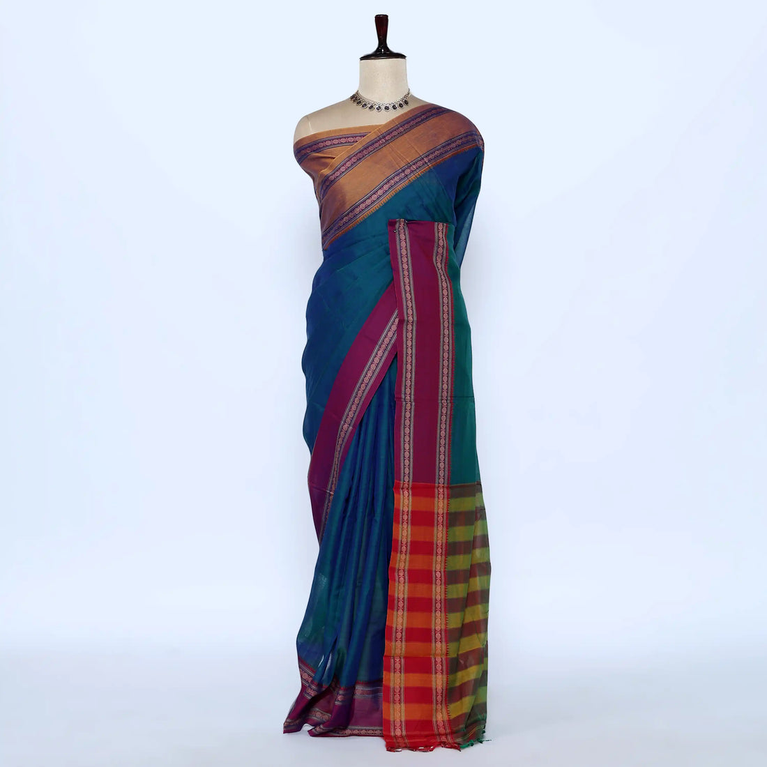 A teal blue and magenta saree with a red and yellow checkered border