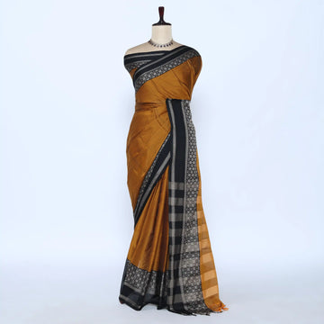A mustard yellow and black saree featuring a black border with a white geometric pattern and a matching black-and-gold checkered pallu.