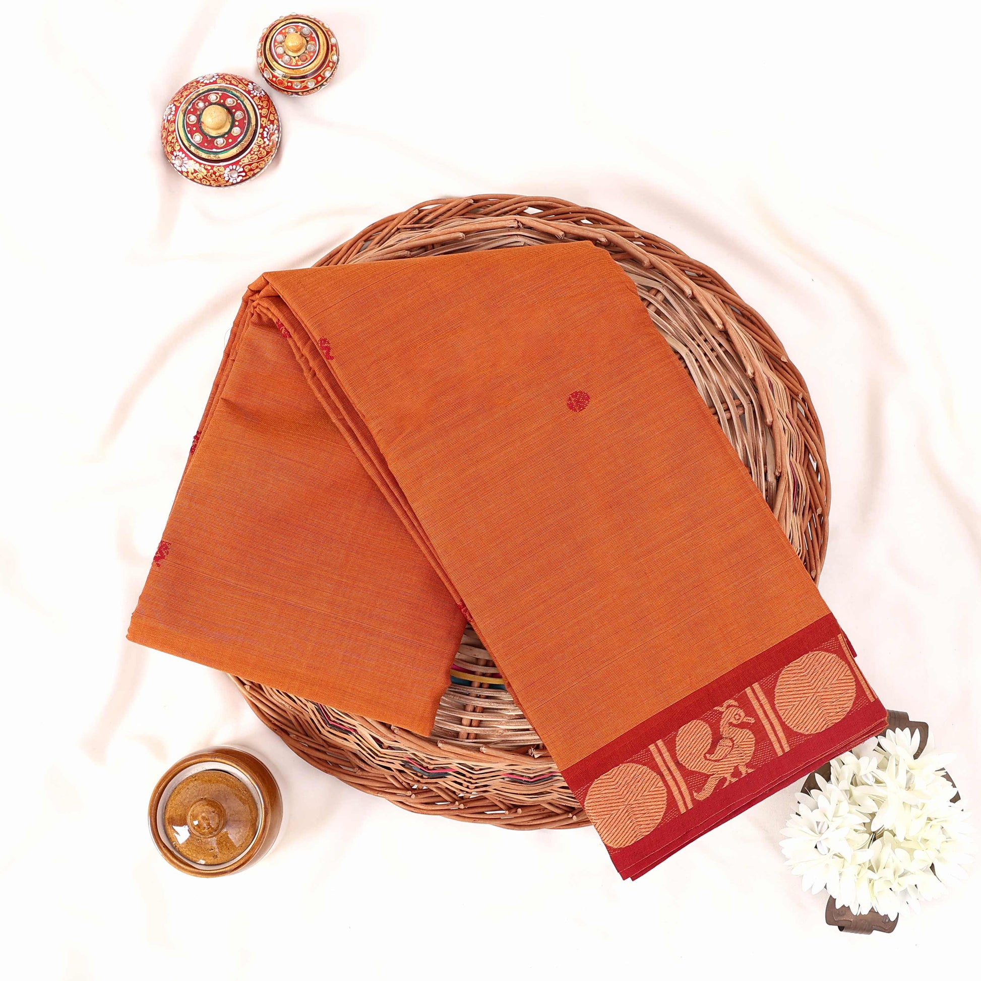 Kanchi Cotton Saree With Maroon Zari Border In Yellow Folded Display View With Decorative Accents
