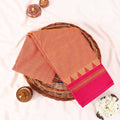 Kanchi Cotton Saree With Contrast Pink Zari Border In Orange Folded Flat Lay Display View
