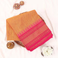 Chettinad cotton saree with orange  body and pink zari temple border folded flat front view 