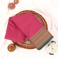 Kanchi Cotton Saree With Gold Zari Border In Pink And Green Neatly Folded On A Wicker Basket Top View Product Display
