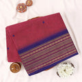 Chettinad cotton saree with zari buttas and zari border in pink and blue folded top view