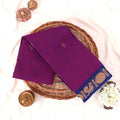 Kanchi Cotton Saree With Gold Zari Border In Vibrant Purple And Blue Neatly Folded On A Wicker Basket Top View Product Display
