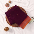 Kanchi Cotton Saree With Gold Zari Motifs And Contrast Orange Border In Deep Purple Folded Top View Display
