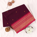 Chettinad cotton saree with zari buttas and zari border in purple and pink folded top view