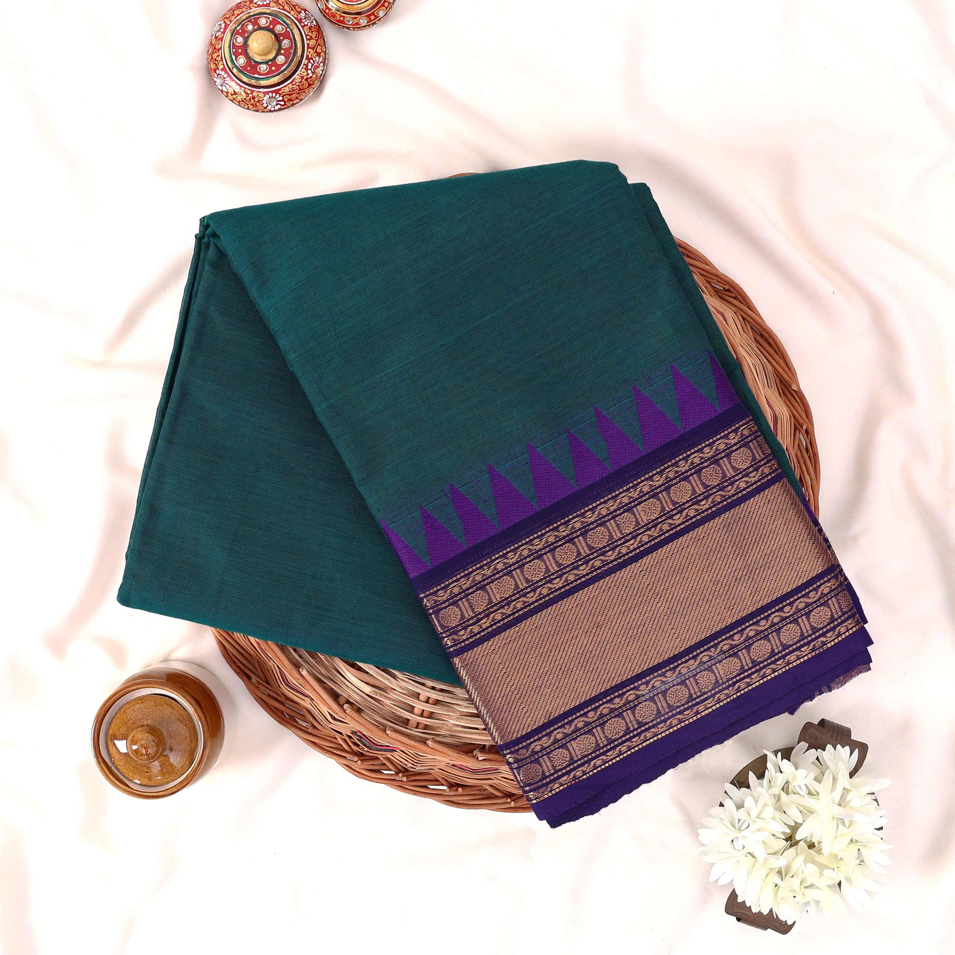 Kanchi Cotton Saree With Teal Green Body Purple Zari Border And Temple Design, Folded Basket Top View
