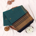 Chettinad cotton saree with zari buttas and zari border in teal and black folded top view
