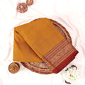 Kanchi Cotton Saree With Zari Woven Maroon Border In Yellow Neatly Folded In Flat Lay Display View
