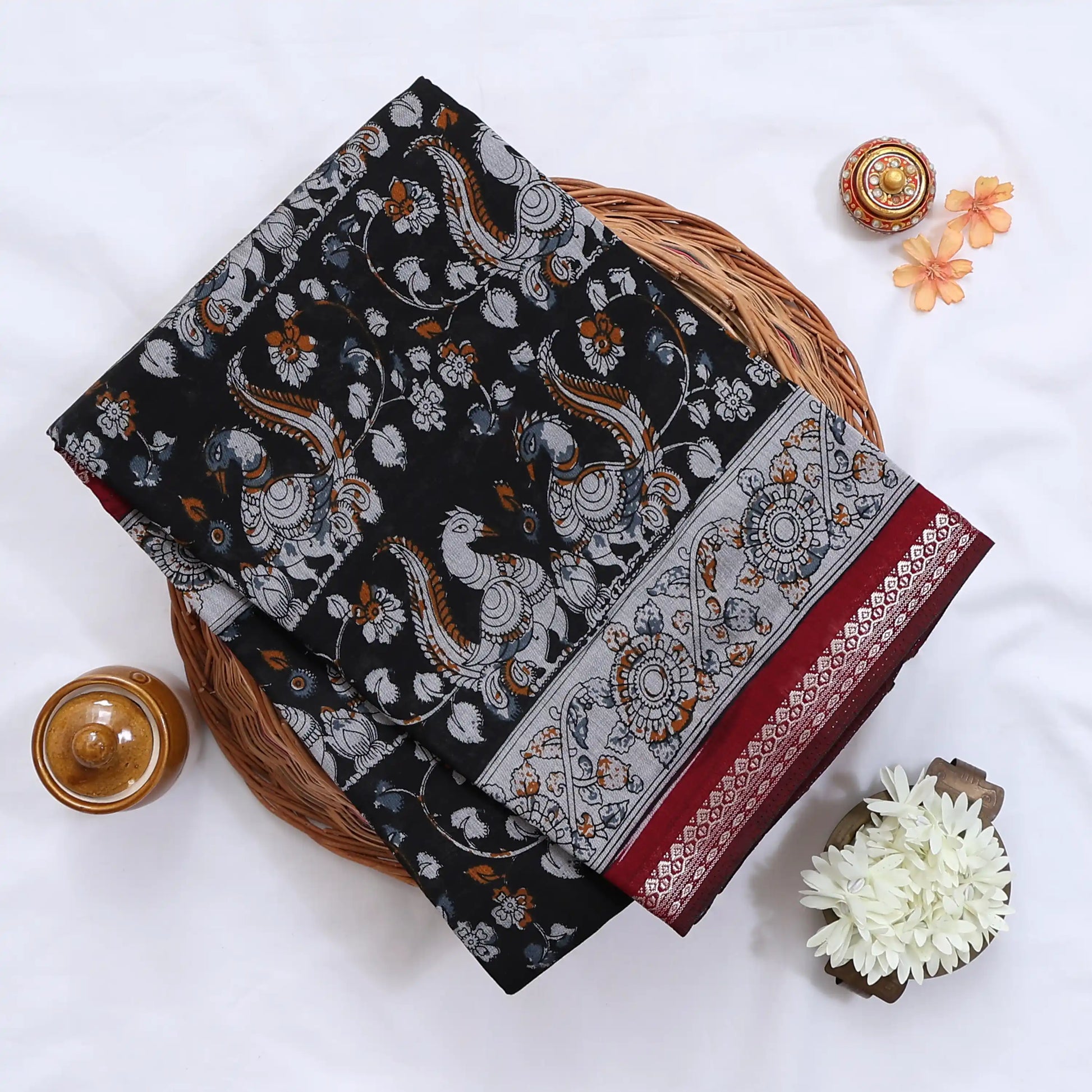 Black Semi Chanderi saree with floral peacock print and contrast woven border folded flat lay display.