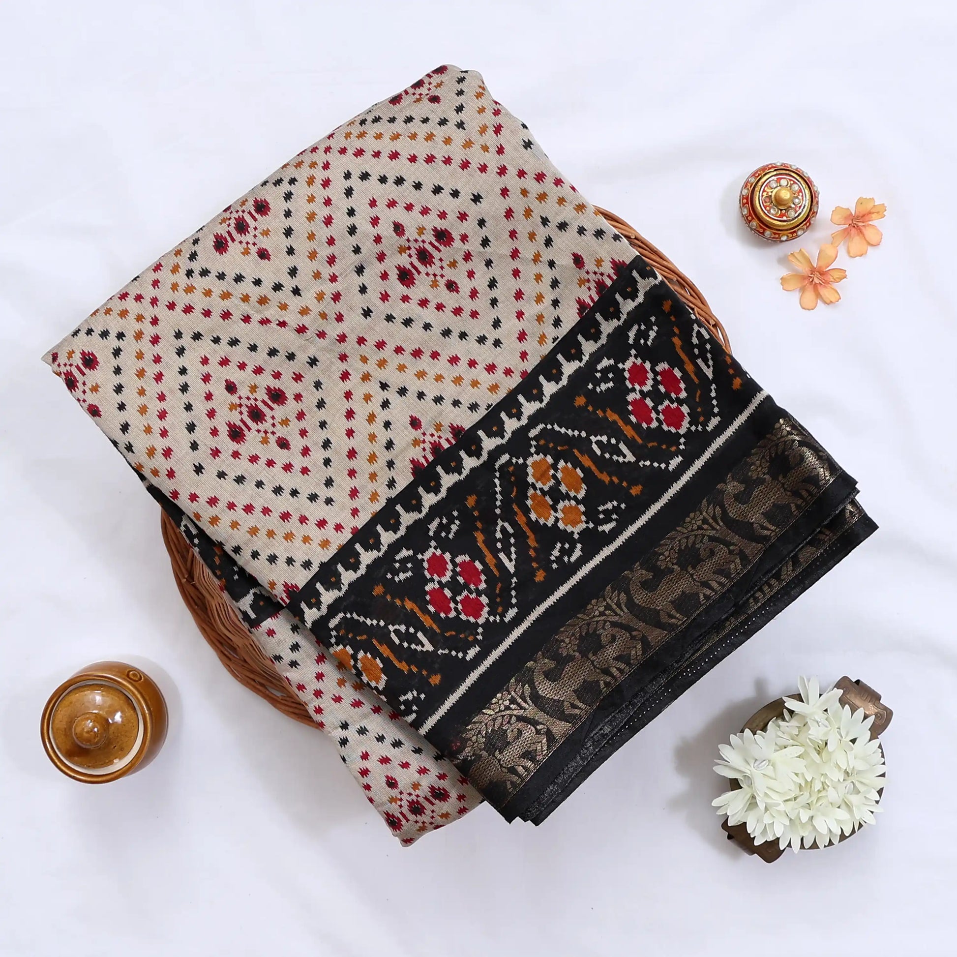 Cream Semi Chanderi saree with bandhani dot print and deer & floral woven border folded flat lay display.