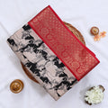 Semi Chanderi saree with cow motif print beige and black body with red zari border folded top view