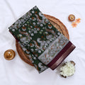 Green Semi Chanderi saree with floral peacock print and contrast woven border folded flat lay display.