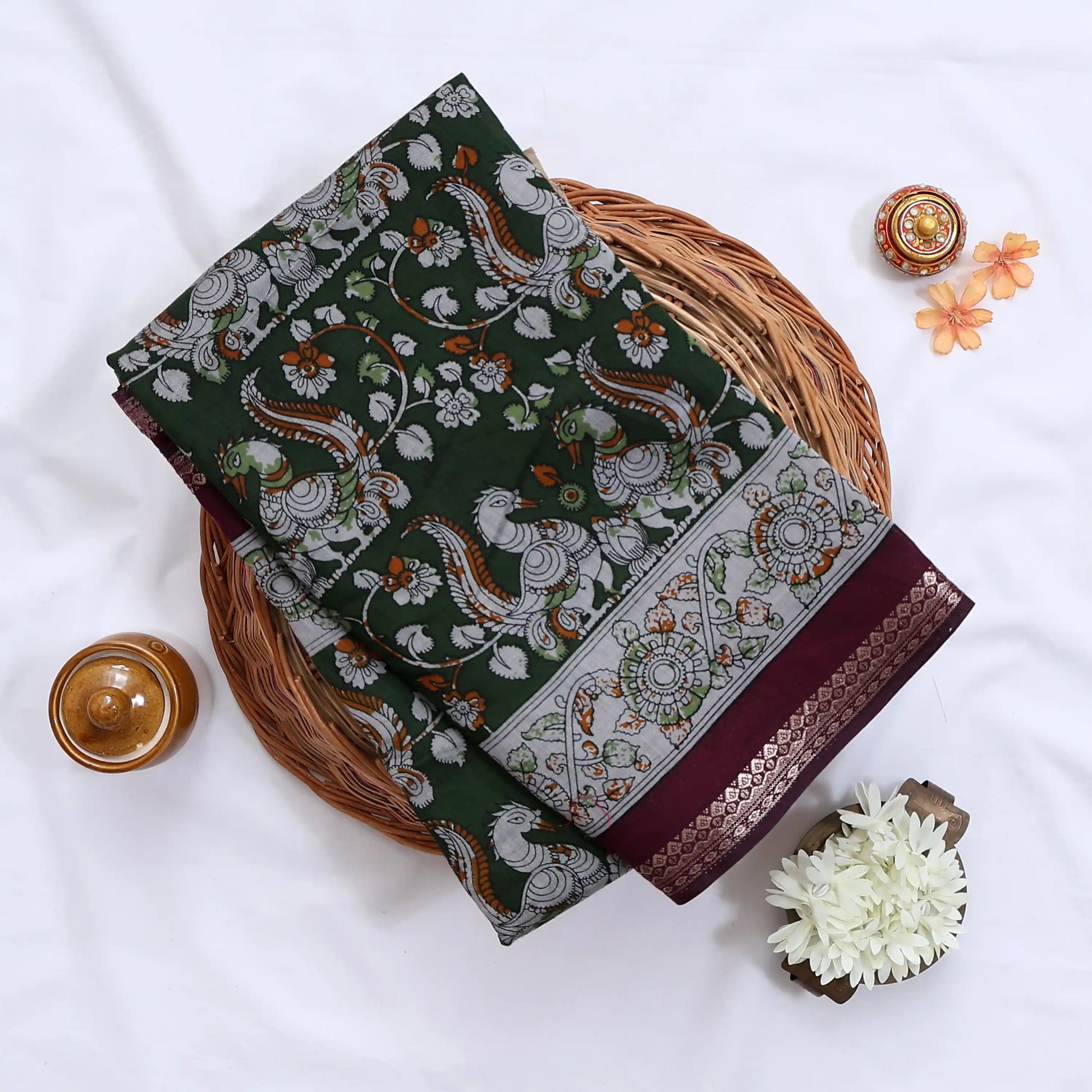 Green Semi Chanderi saree with floral peacock print and contrast woven border folded flat lay display.