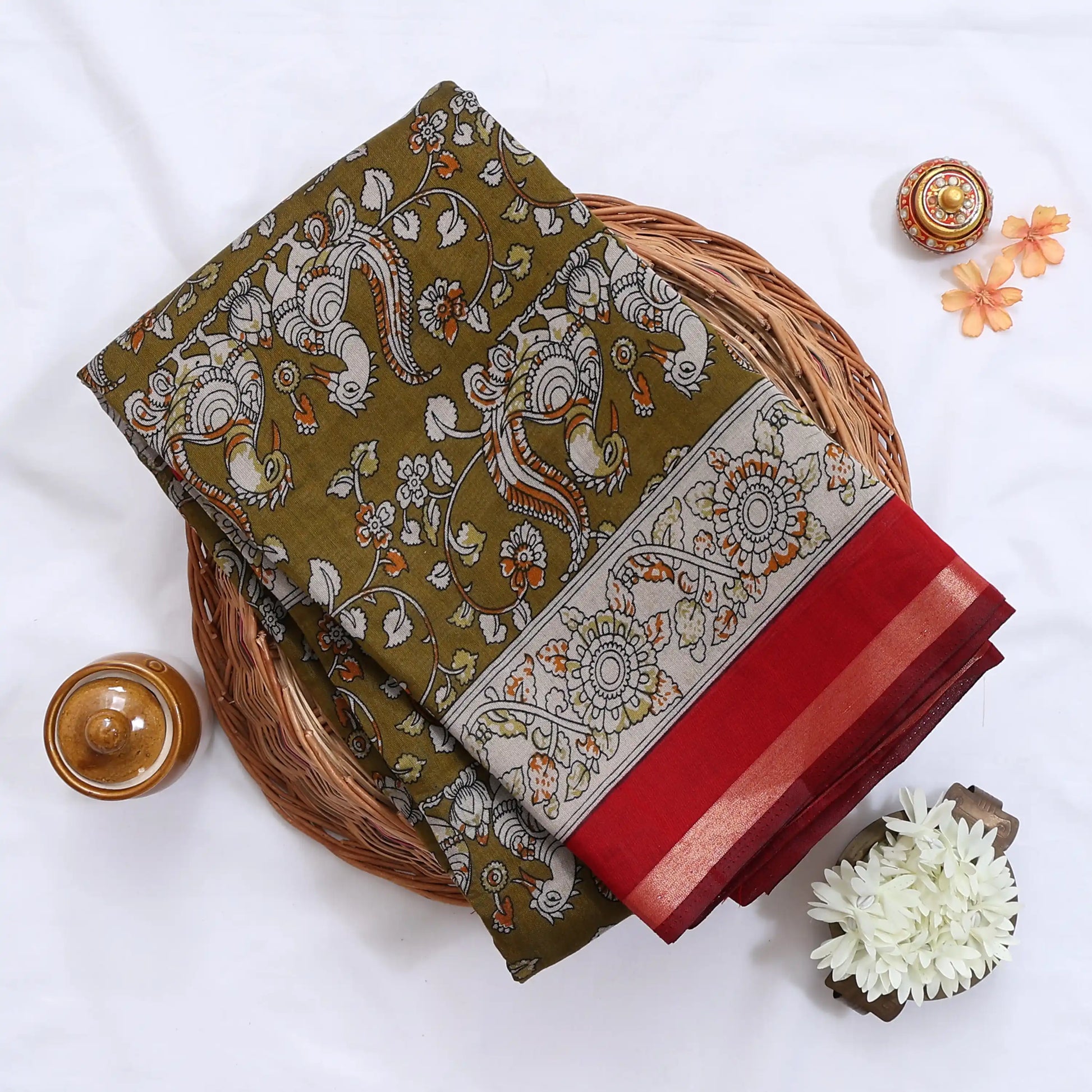 Green Semi Chanderi saree with peacock floral print and contrast woven border folded flat lay display.