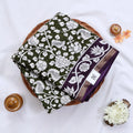 Semi Chanderi saree with white floral print olive green body and purple border folded top view