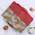 Semi Chanderi saree with cow motif print beige and olive green body with red zari border folded top view