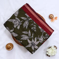 Green semi Chanderi saree featuring white floral print and maroon border folded top view