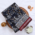Navy Blue Semi Chanderi saree with floral peacock print and contrast woven border folded flat lay display.