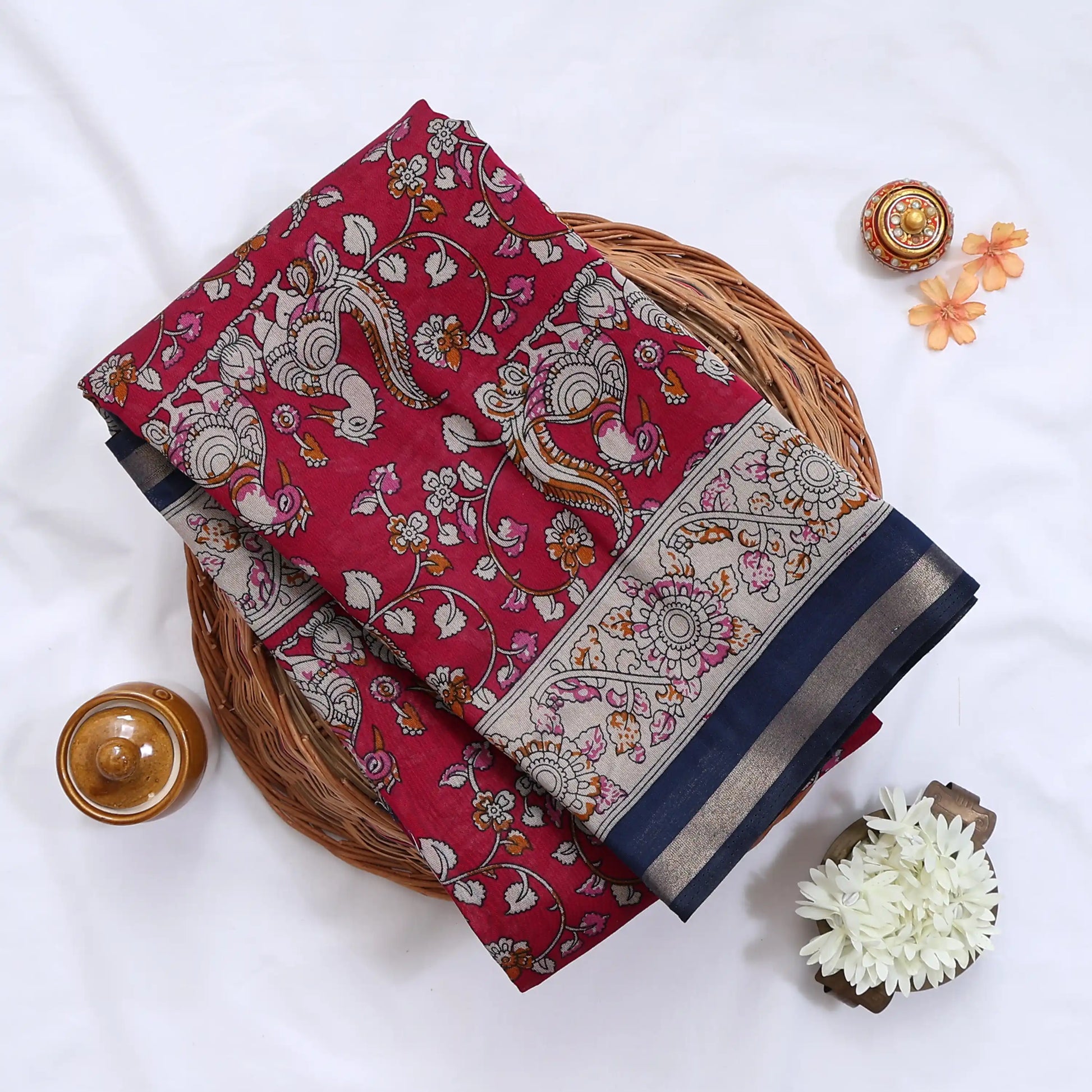 Pink Semi Chanderi  saree with peacock floral print and contrast woven border folded flat lay display.