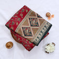 Semi Chanderi saree with floral and bird print in dark green and pink folded close up product view.