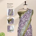 Semi Chanderi saree with floral vine print and broad zari woven border in purple and green front view on mannequin