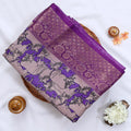 Semi Chanderi saree with cow motif print beige and purple body with purple zari border folded top view