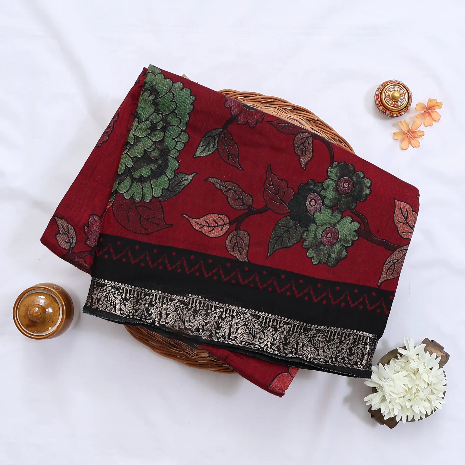 Red Semi Chanderi saree with floral leaf print and contrast zari woven border folded flat lay display.