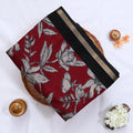Semi Chanderi saree with large floral print red body and black zari border front view on mannequin