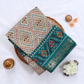 Cream Semi Chanderi saree with bandhani dot print and deer & floral woven border folded flat lay display.
